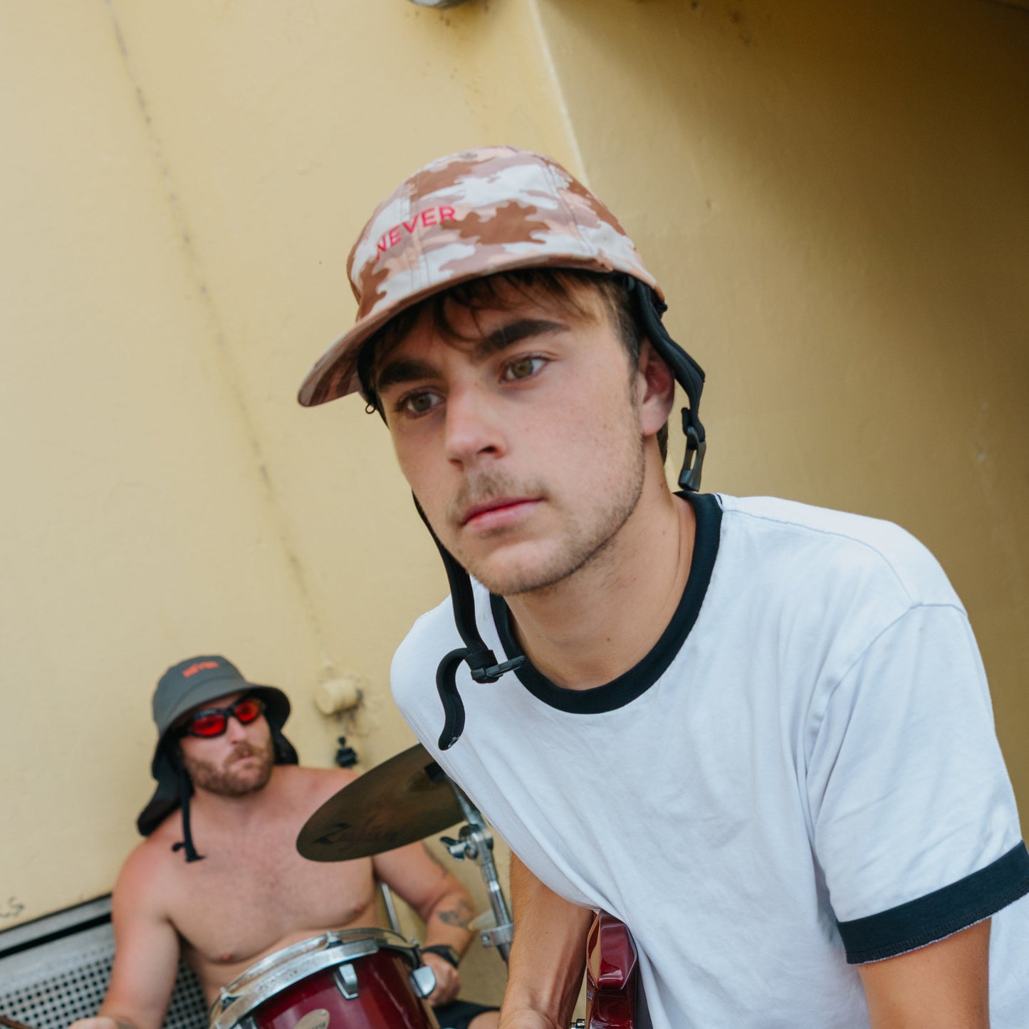 Plow Camo NEVER Surf Cap on guitarist 
