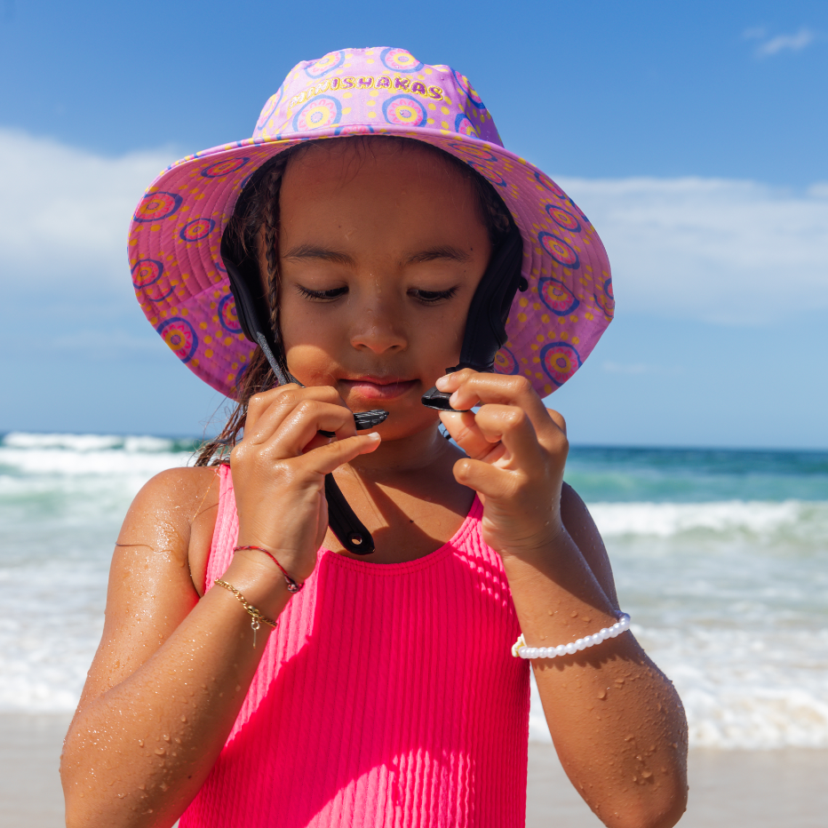 Girl wearing plow surf co surf hat designed by Leihani Zorin Indigenous Australian artist and surfer to support her surfing goals
