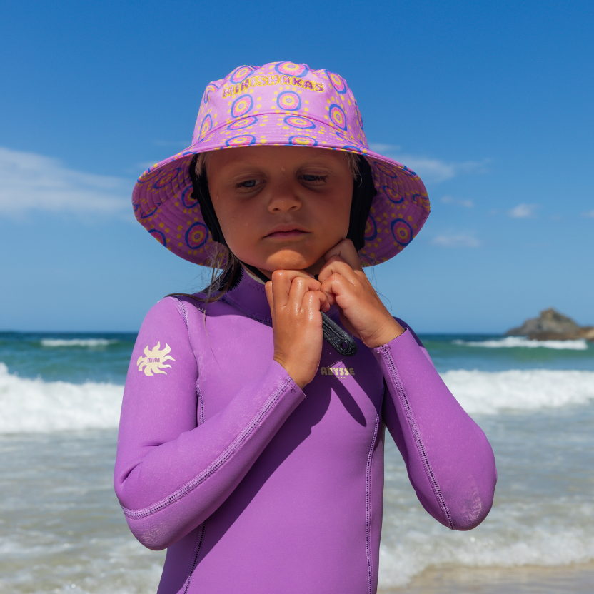 Girl wearing plow surf co surf hat designed by Leihani Zoric Indigenous Australian artist and surfer to support her surfing goals