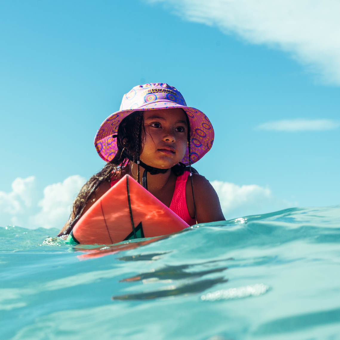 Girl wearing plow surf co surf hat designed by Leihani Zoric Indigenous Australian artist and surfer to support her surfing goals