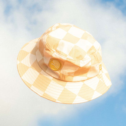 Checkered bucket hat against a blue sky with clouds